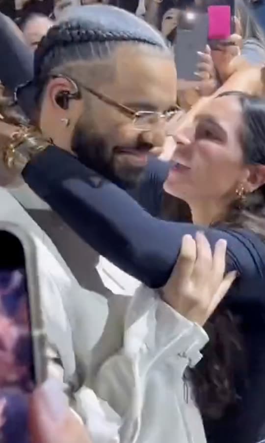 Watch Drake Push Fan Who Tries to Kiss Him at...