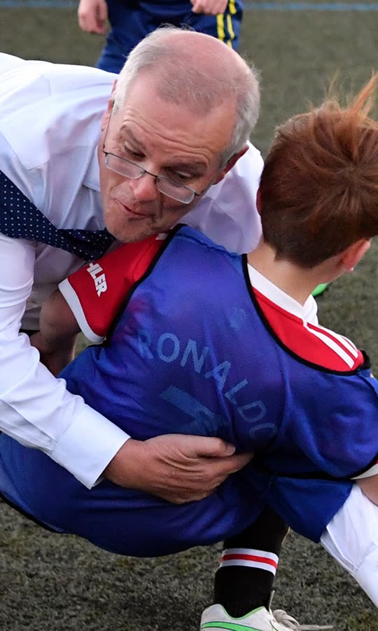 Australian PM  knocks boy over in football