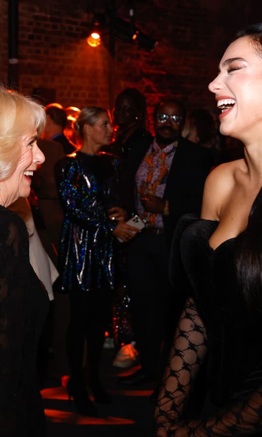 Dua Lipa giggles with Queen Camilla at...